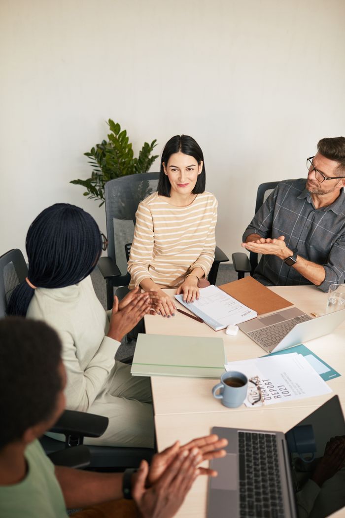 Professional team engaging in discussion in a modern office setting.